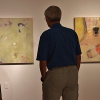 couple admiring contemporary artwork gallery