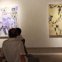 people looking at large abstract art