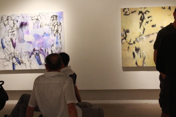 people looking at large abstract art