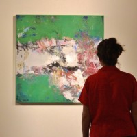 woman viewing art show reception