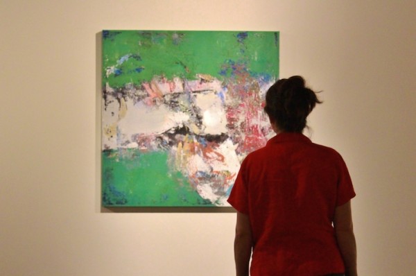 woman viewing art show reception